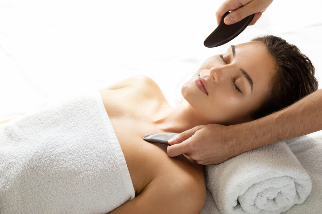 Woman during Chinese traditional massage - Gua Sha
